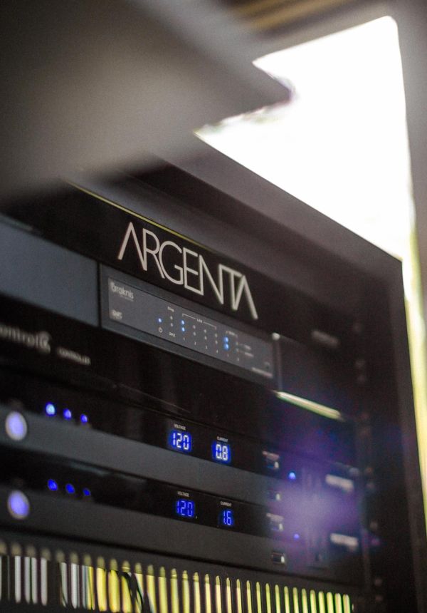 Close-up view of AV equipment rack with Argenta-branded network components